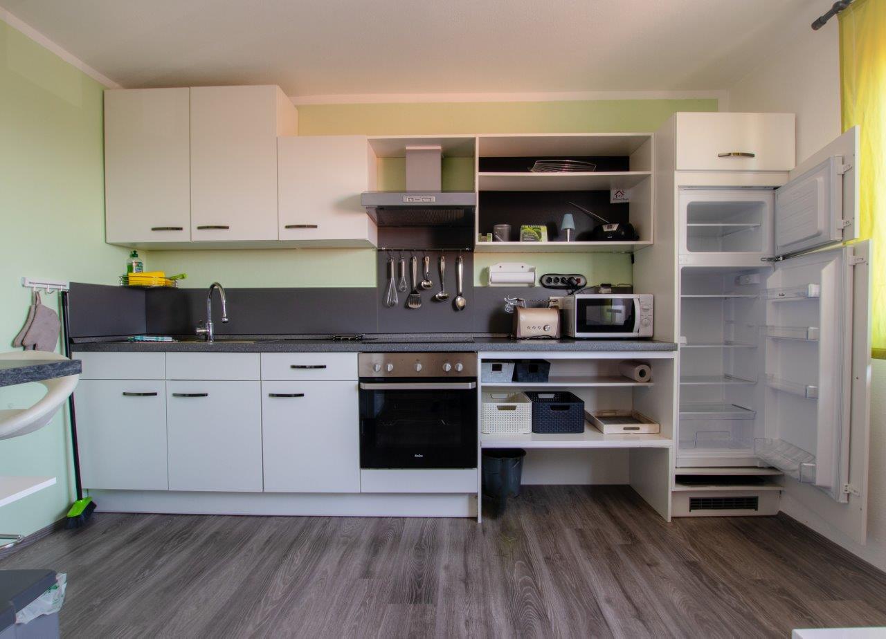 Schicke Küche mit E-Herd und Kühlschrank